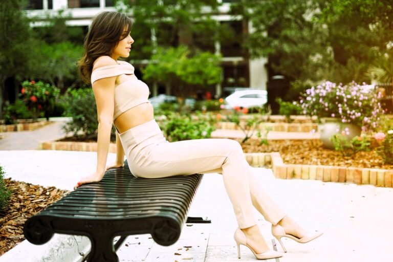 beautiful girl wearing beige high heels sitting on a bench